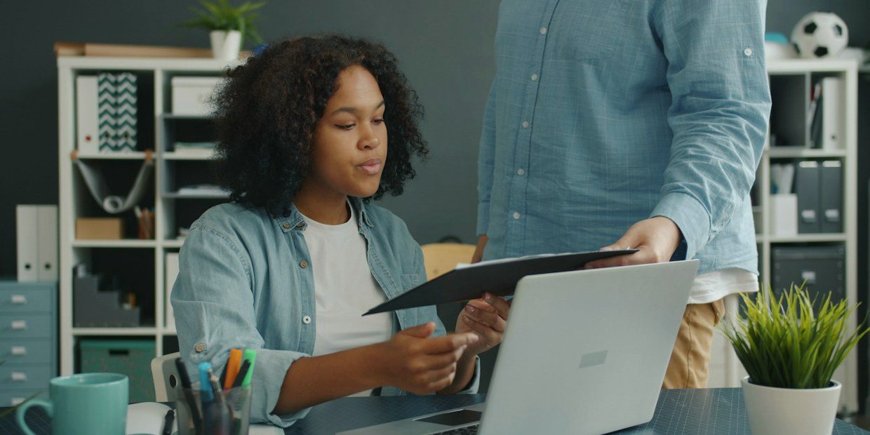 Two colleagues going through a document together at a desk